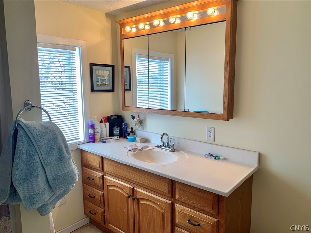 3403 Burke Road Vernon Center, NY 13477 - Photo 20 of 42 Large vanity with cabinet and triple mirror that lets you see all of you.