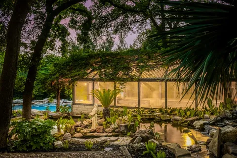 a view of a house with pool and chairs