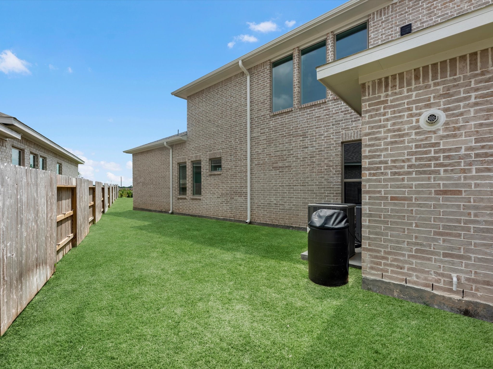 18714 Pistachio Way Manvel, TX 77578 - Photo 43 of 48 Thanks to nearly 170 feet of frontage, the home enjoys separation from its neighboring property, creating a side yard ideal for a future dog run, or simply extra breathing room. This thoughtful placement also allows abundant natural light to fill the primary bath and game room while enhancing privacy throughout the home.