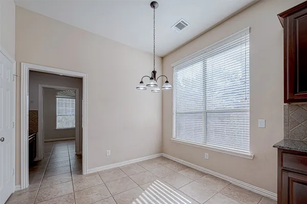 a kitchen with stainless steel appliances granite countertop a sink and cabinets with wooden floor