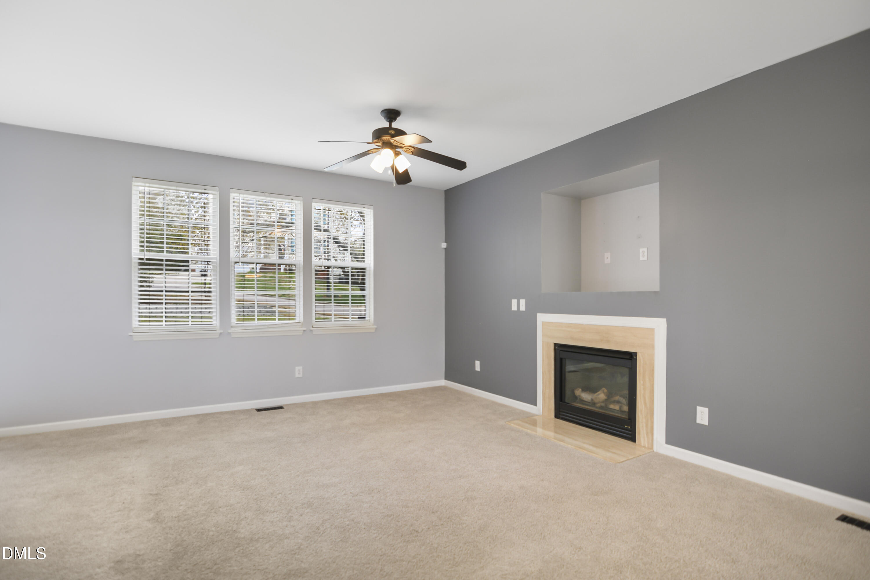 2241 Spruce Shadows Lane Raleigh, NC 27614 - Photo 7 of 29 an empty room with windows and fireplace