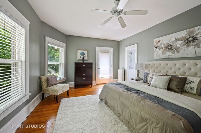 a spacious bedroom with a bed and glass window