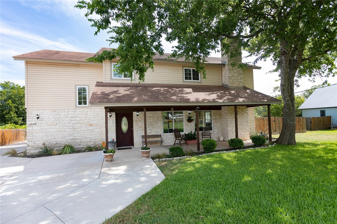 a front view of a house with a garden and plants