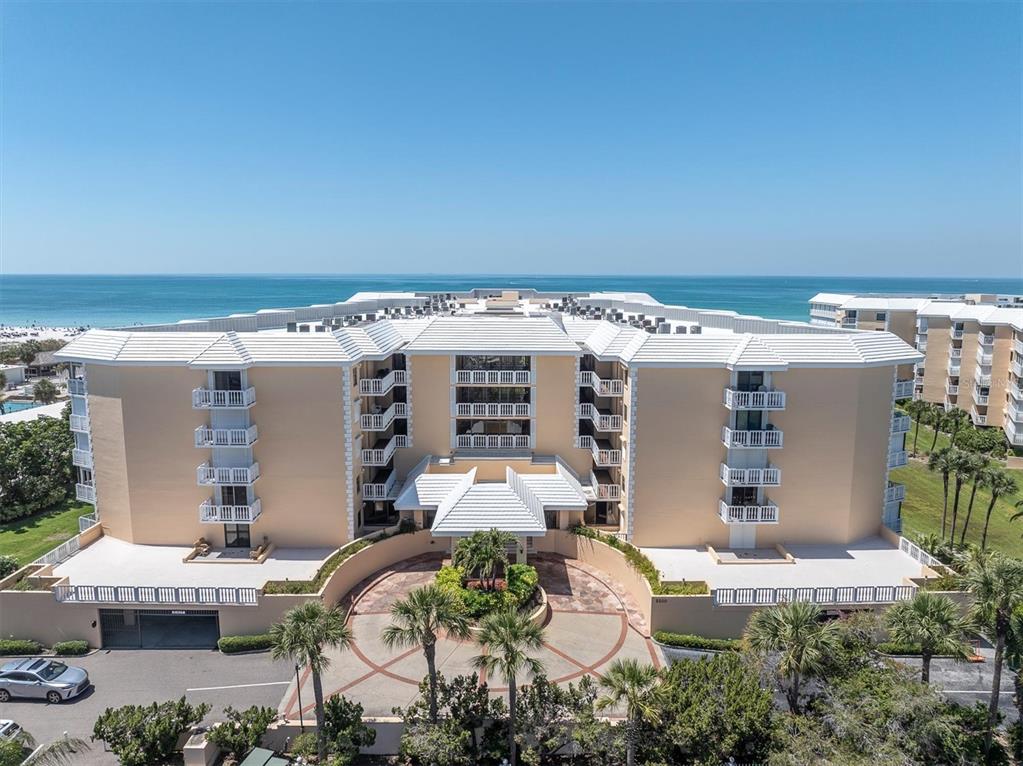 6500 Sunset Way, Unit 316 St. Pete Beach, FL 33706 - Photo 1 of 58 an aerial view of a house with a yard and seating space