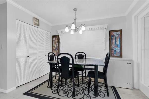a view of a dining room with furniture and chandelier