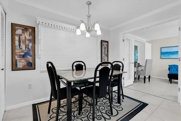a view of a dining room with furniture and chandelier