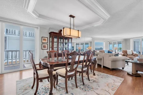 a dining room with furniture window and wooden floor