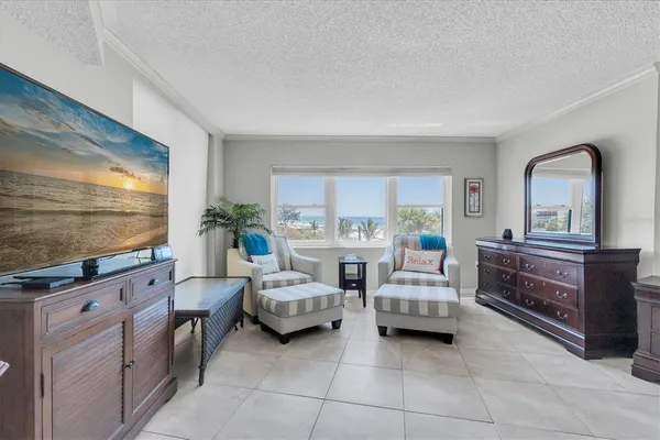 a bedroom with furniture and a flat screen tv