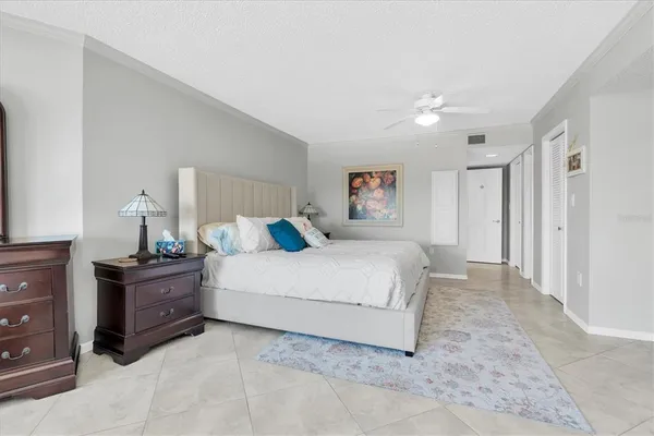 a spacious bedroom with a bed and a cabinets