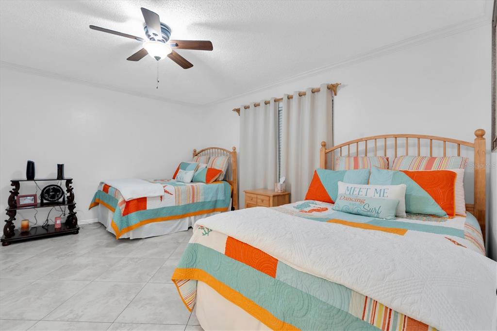 6500 Sunset Way, Unit 316 St. Pete Beach, FL 33706 - Photo 24 of 58 a bedroom with furniture and a bed