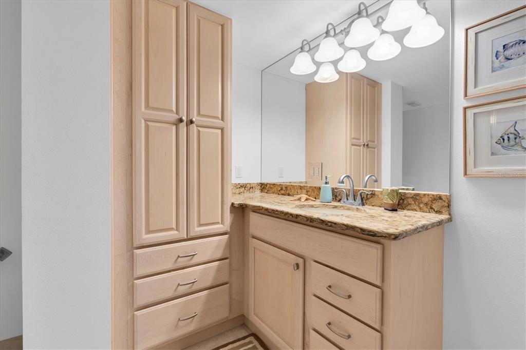 6500 Sunset Way, Unit 316 St. Pete Beach, FL 33706 - Photo 26 of 58 a bathroom with a sink vanity and a mirror