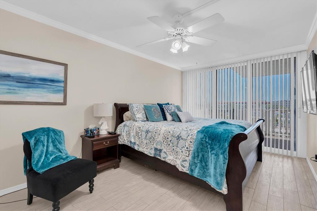 6500 Sunset Way, Unit 316 St. Pete Beach, FL 33706 - Photo 29 of 58 a spacious bedroom with a bed and a couch