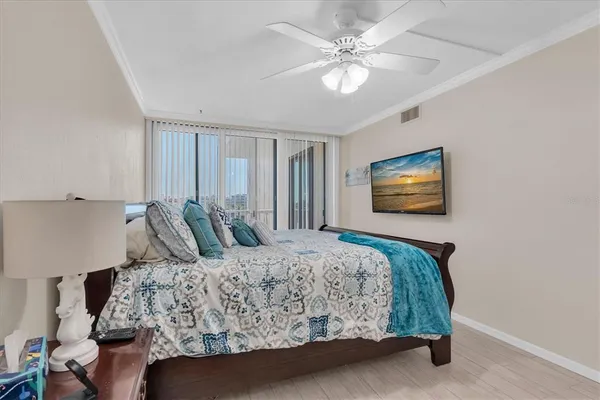 a bedroom with a bed and a chandelier