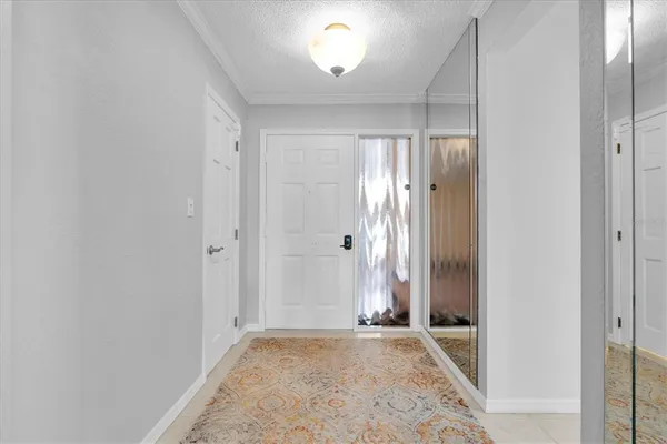 an empty room with closet and windows