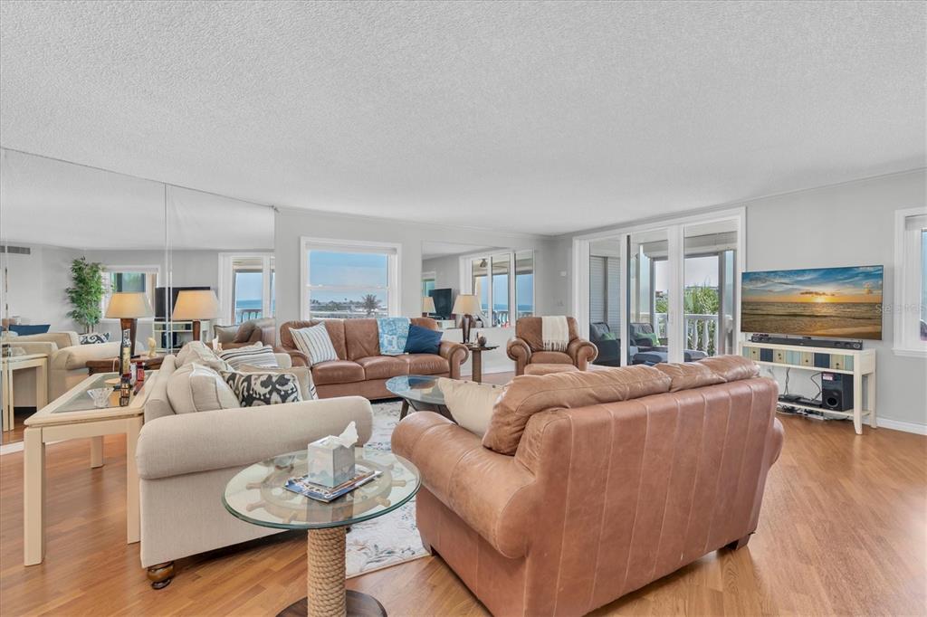 6500 Sunset Way, Unit 316 St. Pete Beach, FL 33706 - Photo 5 of 58 a living room with furniture and a flat screen tv