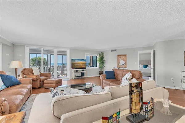 a living room with furniture window and a flat screen tv