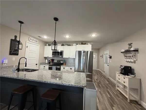 a kitchen with refrigerator and microwave