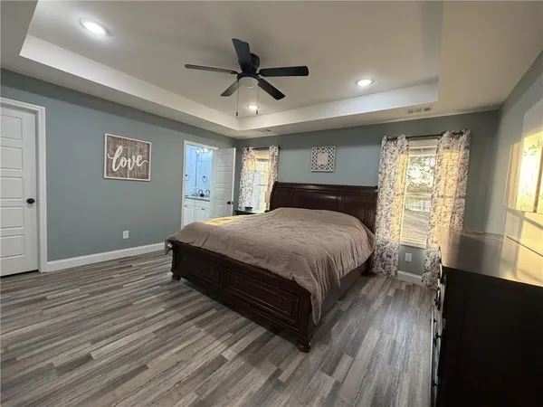 a bedroom with a large bed and a large window