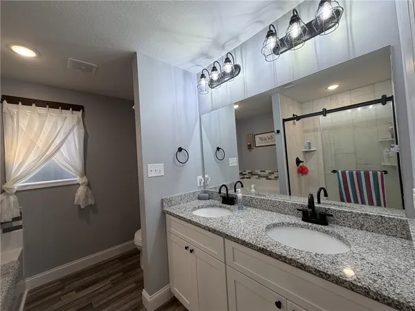 a bathroom with a double vanity sink and a mirror