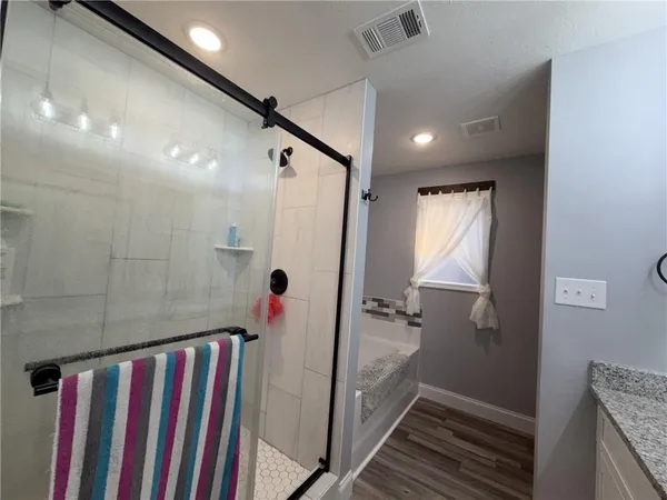 a bathroom with a mirror and a shower