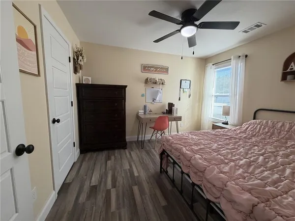 a bed room with a bed and a ceiling fan