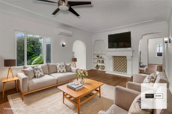 a living room with furniture a fireplace and a flat screen tv
