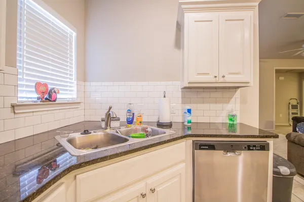 a kitchen with a sink cabinets and window