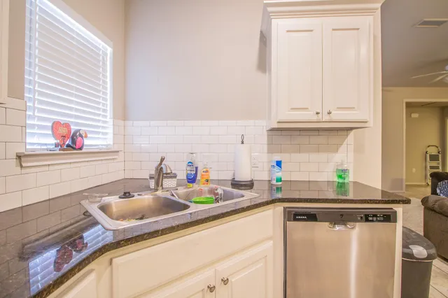 a kitchen with a sink cabinets and window