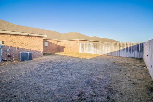 a view of a back yard with an empty space