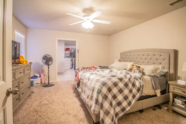 a bedroom with a bed and a chandelier