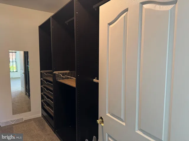 a bathroom with a double vanity sink toilet and a tub