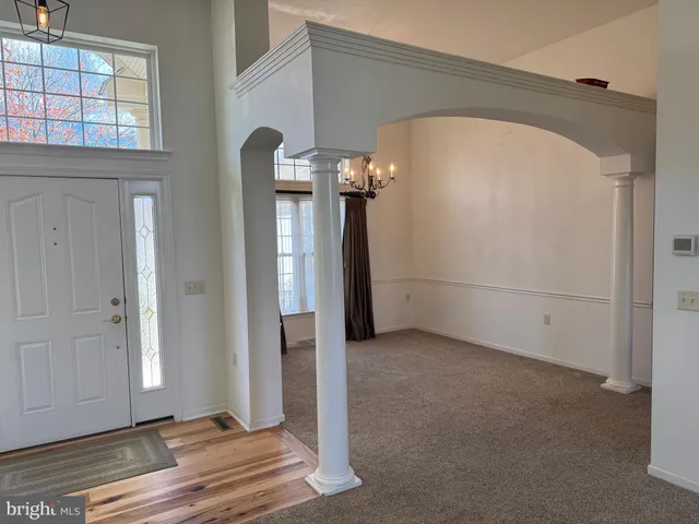 a view of a livingroom with an empty space and a fireplace