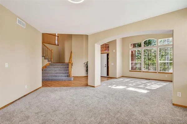 a view of a livingroom with wooden floor and a window