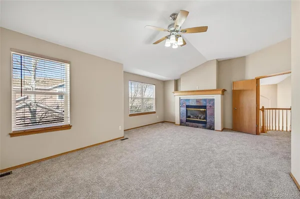 a view of a livingroom with an empty space and a fireplace