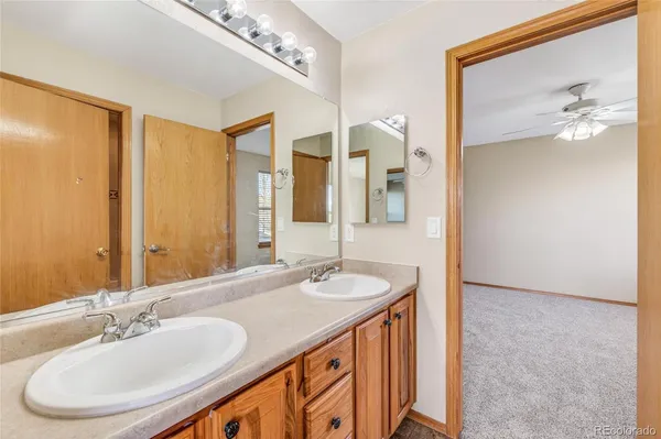 a bathroom with a double vanity sink and a mirror