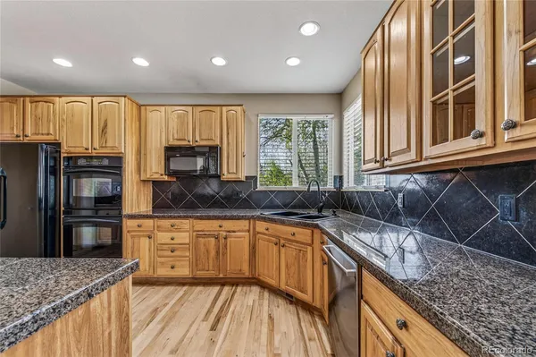 a kitchen with a sink a counter top space cabinets and stainless steel appliances