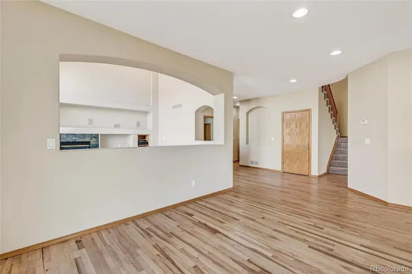 a view of a kitchen with wooden floor and a large window