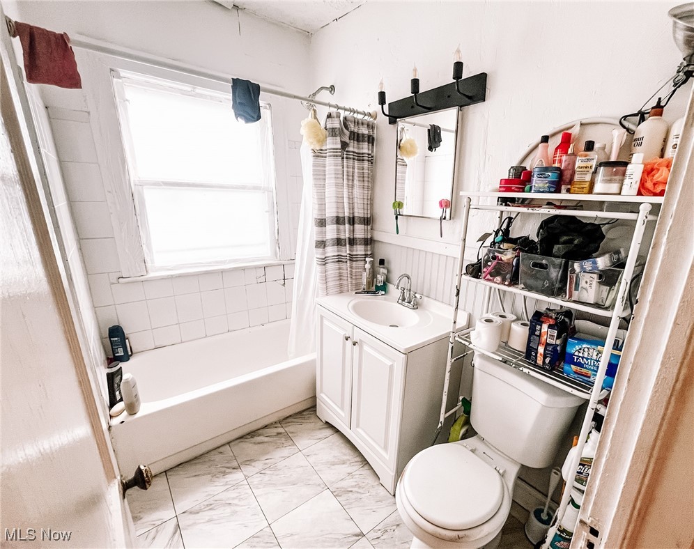 1547 Hillcrest Road Cleveland, OH 44118 - Photo 14 of 23 First Floor Full bathroom with tile patterned floors, shower / bath combo with shower curtain, vanity, and toilet