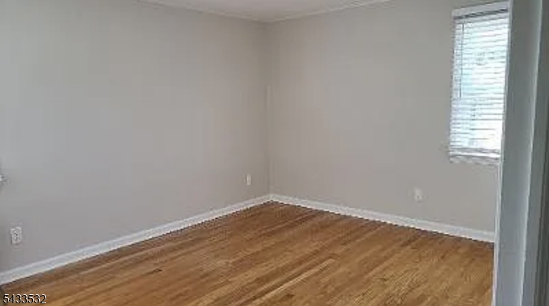 16 Ocean Street Millburn, NJ 07041 - Photo 22 of 26 wooden floor in an empty room with a window