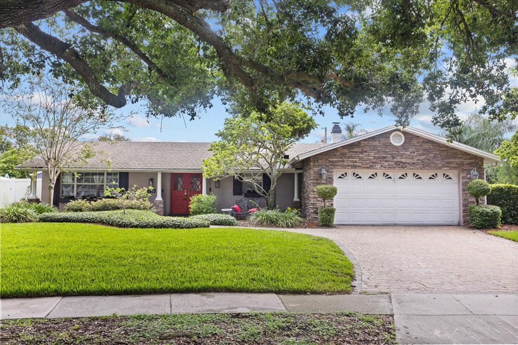 756 Friar Road, Unit 13 Winter Park, FL 32792 - Photo 1 of 1 a front view of a house with a yard and garage