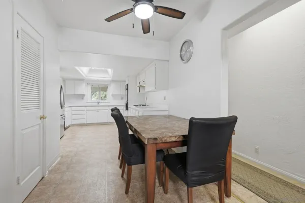 a view of a dining room with furniture and a chandelier