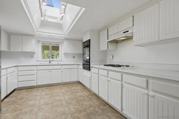 a kitchen with a sink and cabinets