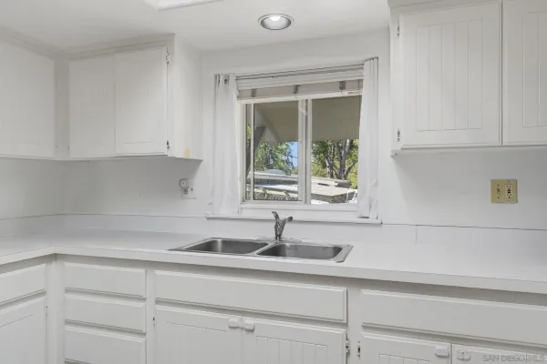 a kitchen with granite countertop cabinets and steel stainless steel appliances