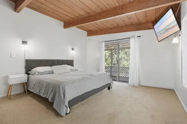 a bed sitting in a bedroom next to a window