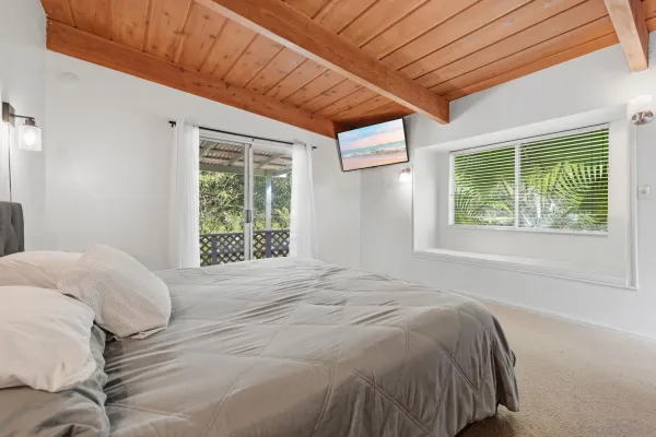 a bedroom with a large bed and a window