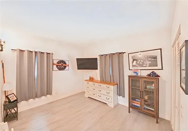 a bedroom with furniture and wooden floor