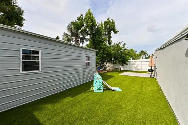 a view of a backyard with swimming pool
