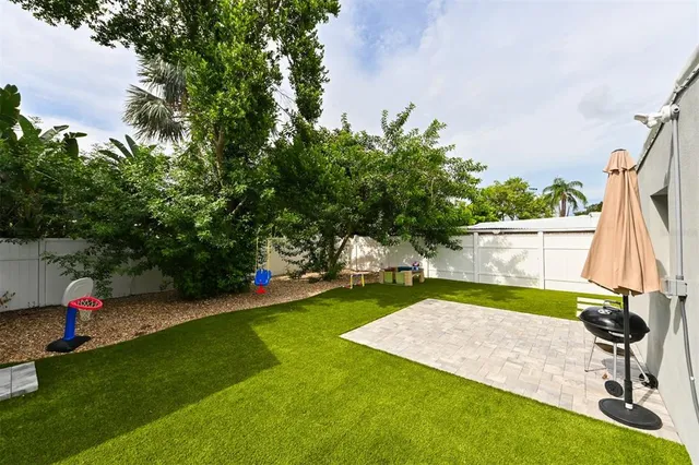 a view of a backyard with swimming pool
