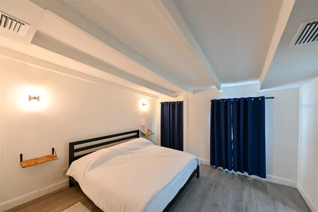 a bed room with a bed and a large mirror