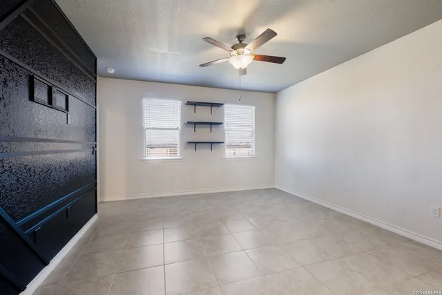 a view of a kitchen with a sink and a chandelier fan